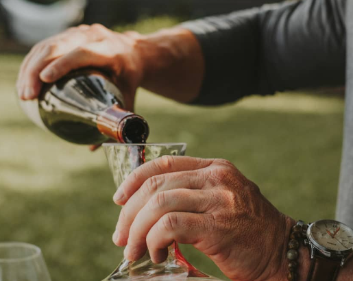 A man pours red wine into a decanter. Photo courtesy of The Good Pour.