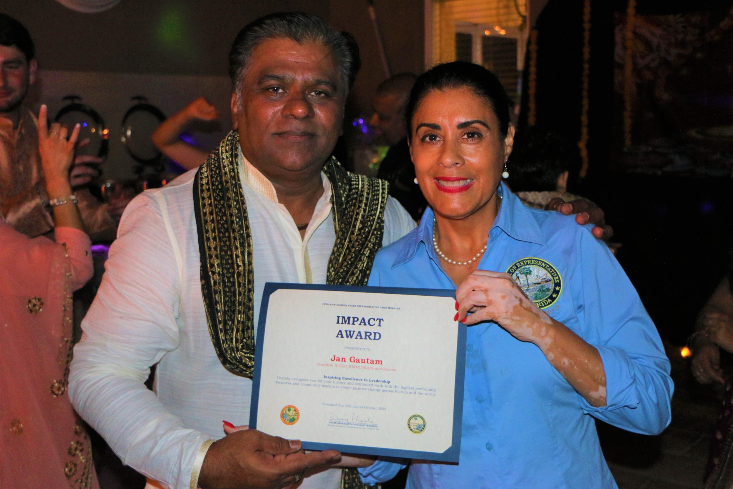 State Representative Daisy Morales presents business leader and hotelier Jan Gautam with the 2022 Impact Award in Kissimmee Friday, October 28, 2022. (Florida National News Photo/J Willie David, III)